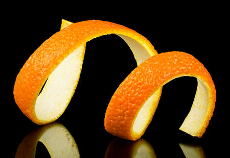 Spiral orange zest on a black background. Citrus twist peel. Citrus fruit.の写真素材