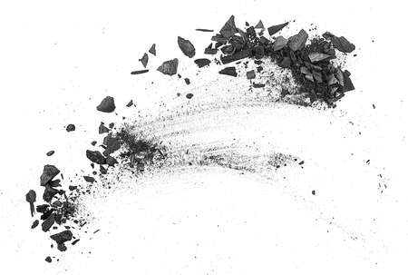 Black charcoal particles on a white background, top view. Activated charcoal powder for facial mask.の写真素材