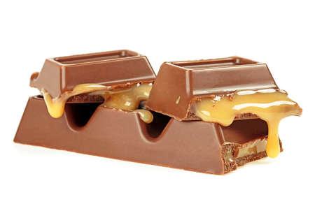 Tasty chocolate bar with caramel isolated on a white background. Broken candy bar.の写真素材