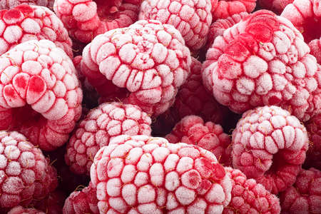 Fresh summer berries - frozen raspberries, covered with hoarfrost. Healthy food.の写真素材