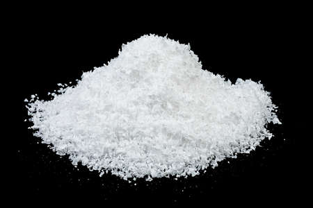 Heap of white snow on black background. Sparkling fluffy white snow hill.の写真素材