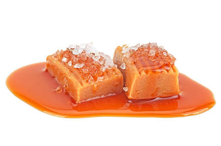 Delicious sweets with caramel sauce and salt isolated on a white background. Salted caramel candies.の写真素材
