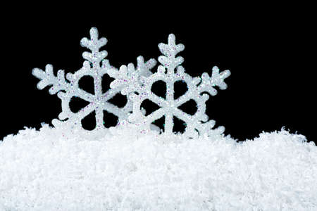 Christmas decoration - pile of white snow and snowflakes on a black background.の写真素材