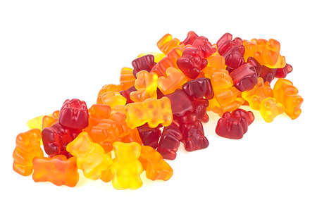 Colorful fruity flavor gummy bears isolated on a white background. Heap of jelly bears.の写真素材