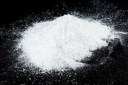 Snow hill on a black background, close-up. Pile of snow crystals.の写真素材