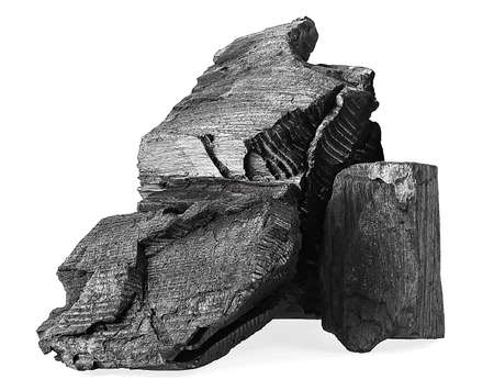 Pile of natural black activated charcoal isolated on a white background. Traditional charcoal.の写真素材