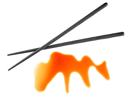 Splashes of soy sauce and wooden chopsticks isolated on a white background, top view. Japanese food.の写真素材