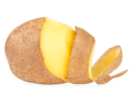 Peeled potatoes with peel isolated on a white backgroundの写真素材