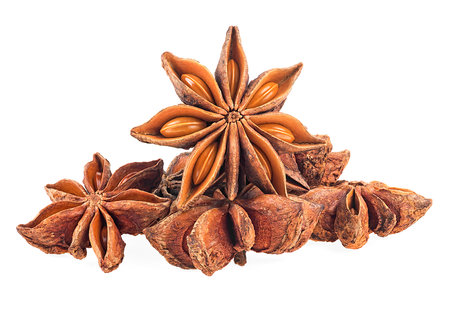 Pile of anise star spice fruits and seeds isolated on a white backgroundの写真素材