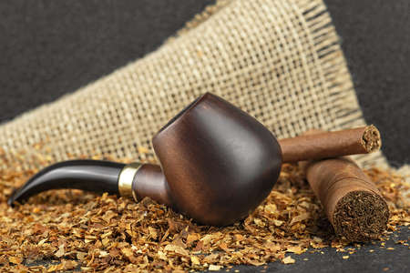 Classic wooden pipe with cigars and tobacco on linen canvas backgroundの写真素材