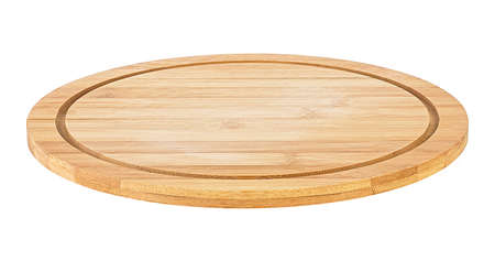 Empty round bamboo pizza board isolated on a white background. Wooden plate for meat and vegetables.の写真素材