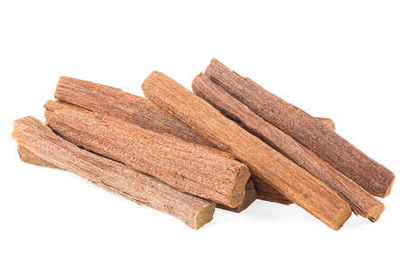 Pile of sandalwood sticks isolated on a white background. Chandan or sandalwood.の写真素材