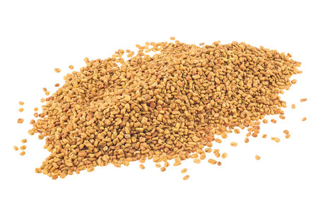 Pile of dried fenugreek seeds isolated on a white backgroundの写真素材
