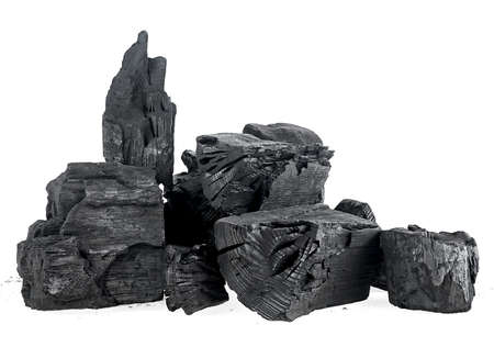 Pile of hardwood charcoal isolated on a white background. Natural wood charcoal. Black charcoal chunks.の写真素材