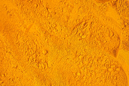 Turmeric powder pile as background and texture, top view. Curcuma longa.の写真素材