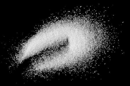 Pile of sea salt on a black background, top view.の写真素材