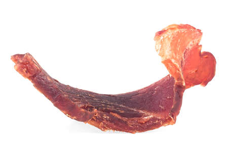 Pork jerky slice isolated on a white background. Piece of dried meat.の写真素材