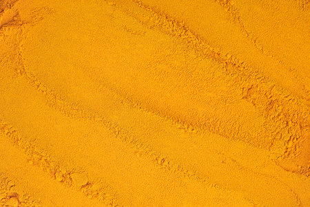 Turmeric powder pile as background and texture, top view.の写真素材