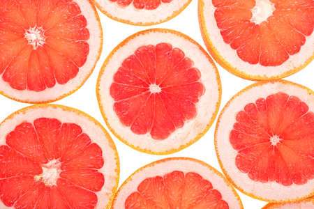 Texture of a ripe grapefruit slices on a white background, close up. grapefruit background.の写真素材