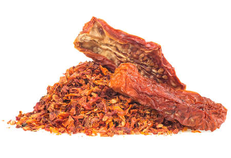 Tomato flakes pile and dried tomatoes isolated on a white backgroundの写真素材