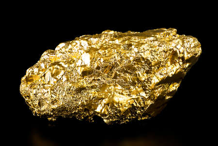 Big gold nuggets on a black background. gold ore.の写真素材