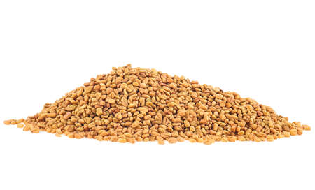 Pile of fenugreek seeds spice isolated on a white background. Methi Dana.の写真素材