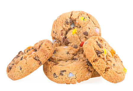Sugar cookies with colorful candies and chocolate drops isolated on a white backgroundの写真素材