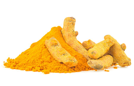Pile of dried turmeric roots and curcuma powder isolated on a white backgroundの写真素材