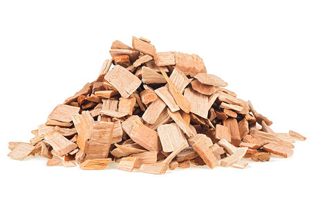 Pile of wood chips from alder tree. Wooden chips for smoking meat and fish isolated on a white background.の写真素材