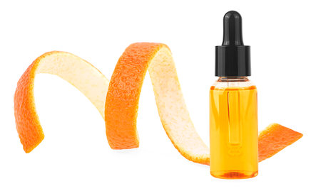 Orange peel and orange essential oil isolated on a white background. Vitamin C serum in cosmetic bottle. Organic SPA cosmetics.の写真素材