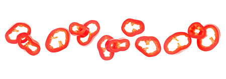 Red chili pepper slices isolated on a white background, top view. Ingredient concept of raw food.