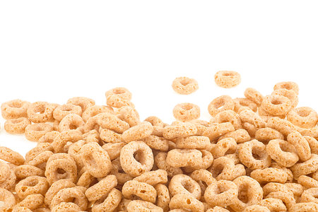Breakfast cereal sweet rings isolated on a white background, front view. Pile of oat cereal.