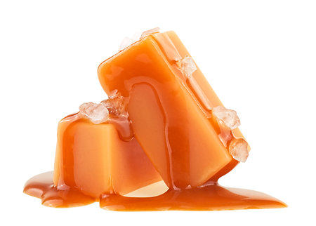 Delicious candies with caramel sauce and sea salt isolated on a white backgroundの写真素材