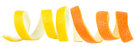 Fresh skin of lemon and orange fruit isolated on a white background. Citrus spiral peels.の写真素材