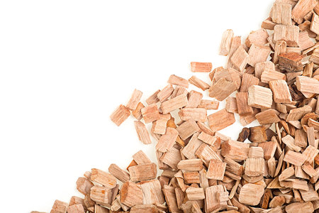 Pile of apple wood chips for flavoring barbecue and grilled foods isolated on a white background, top view.の写真素材