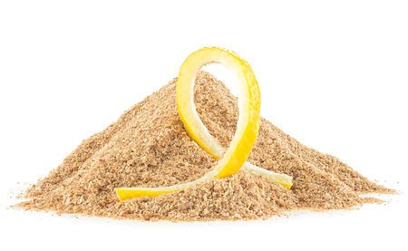 Pile of dried lemon peel powder and fresh lemon skin isolated on a white backgroundの写真素材