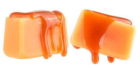 Caramel candies in liquid caramel isolated on a white background. Levitating caramel candies.の写真素材