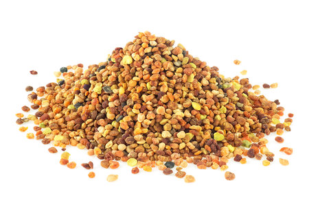 Pile of bee pollen grains isolated on a white background, close-up. Organic bee pollen.の写真素材