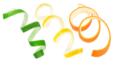 Fresh peel of lemon, orange and lime fruit isolated on a white background. Citrus zest spirals.の写真素材