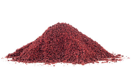 Heap of ground sumac spice isolated on a white backgroundの写真素材