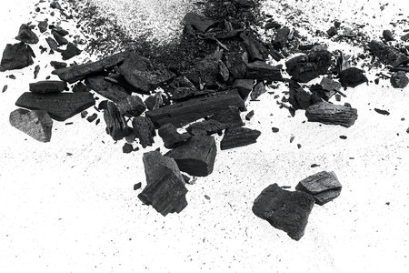 Black charcoal particles on a white background. Activated charcoal powder.の写真素材