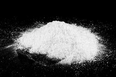 Concept of the New Year and Christmas holidays - pile of white fluffy snow isolated on black background.の写真素材