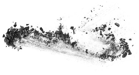 Activated charcoal powder. Black charcoal particles isolated on a white background, top view.の写真素材