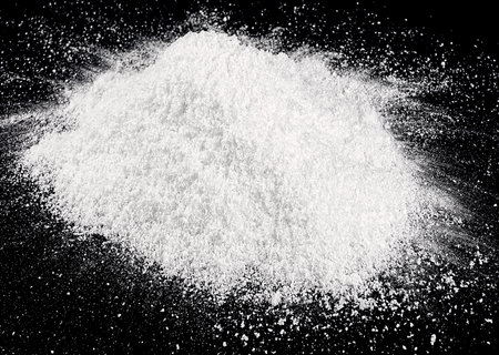 Pile of white fluffy snow isolated on dark backgroundの写真素材