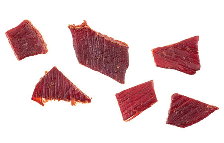 Pieces of beef jerky meat isolated on white background, top view.の写真素材