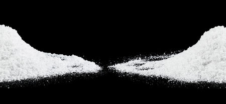 Fluffy white snow isolated on a black background. Snow hills at night.の写真素材