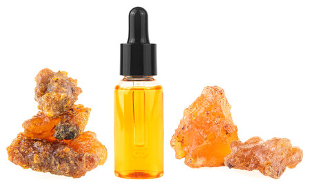 Bottle of essential oil with frankincense resin isolated on a white background. Olibanum aromatic resin. Incense and perfumes.の写真素材