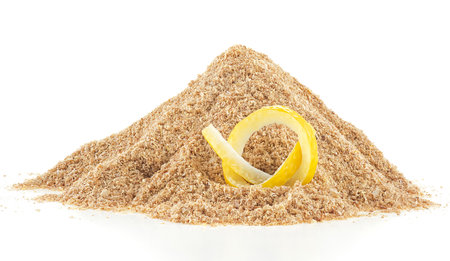 Pile of dried lemon zest and fresh lemon skin isolated on a white backgroundの写真素材