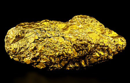 Pure gold ore on a black background. Big gold nugget.の写真素材