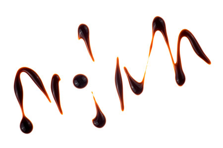 Drops of balsamic vinegar isolated on s white background, top view. Balsamic vinegar cream, Italian salad dressing.の写真素材